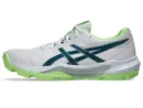 Asics Gel Peake 3 cricket shoe in white and navy, highlighting the dimpled rubber sole and reinforced toe area.