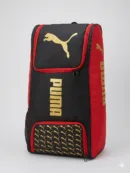 Puma Junior Duffle Wheeler 093193 01 in Black/White, highlighting the integrated wheels, shoulder straps, and large Puma Cat branding.
